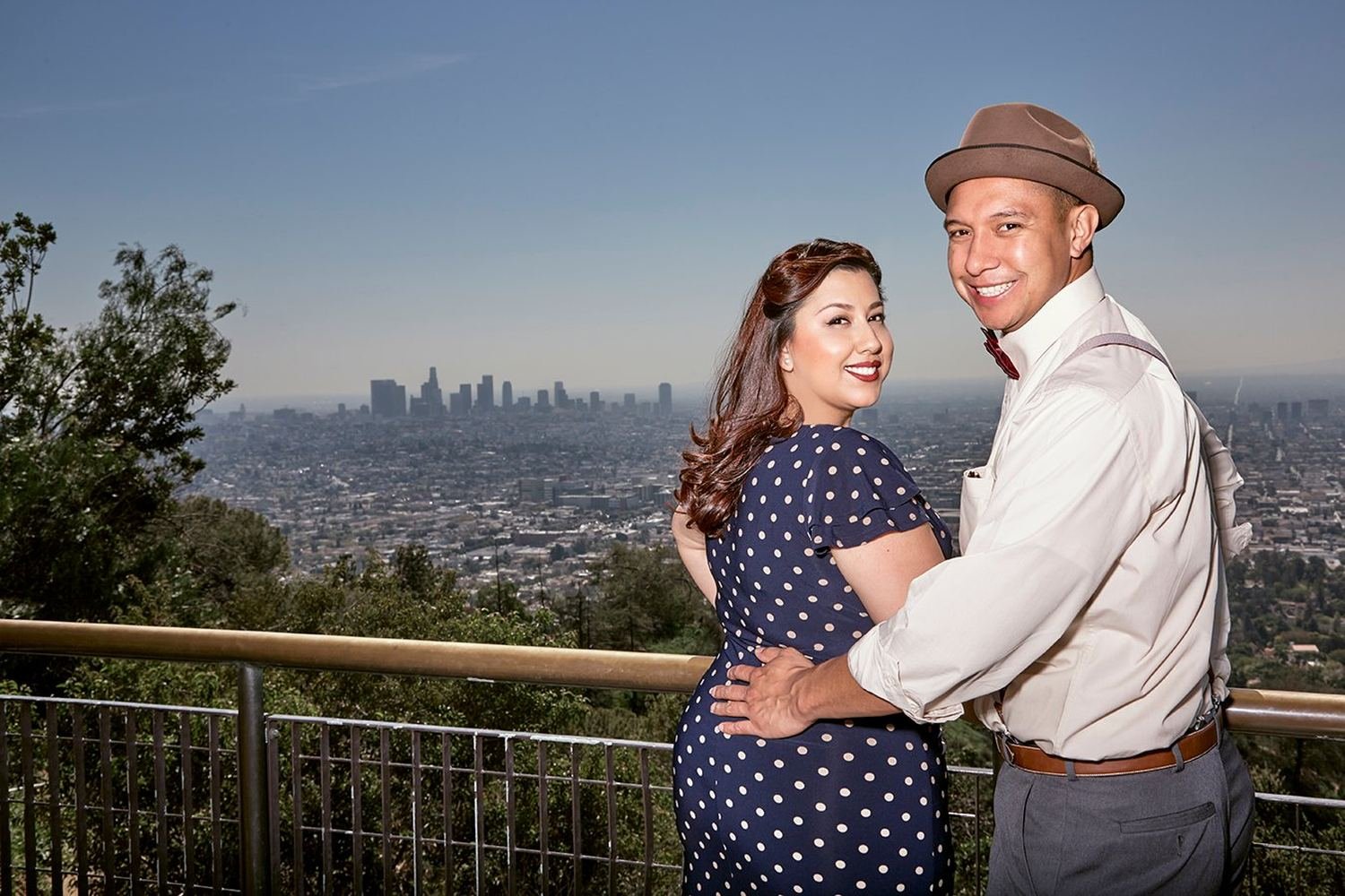 Bride and groom at golden hour above the Los Angeles skyline from Mount Hollywood